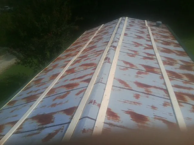 Rusted metal roof panels with new wood purlins before replacement — Storm Damage Roof Repair in Cornville by Roofing Brothers